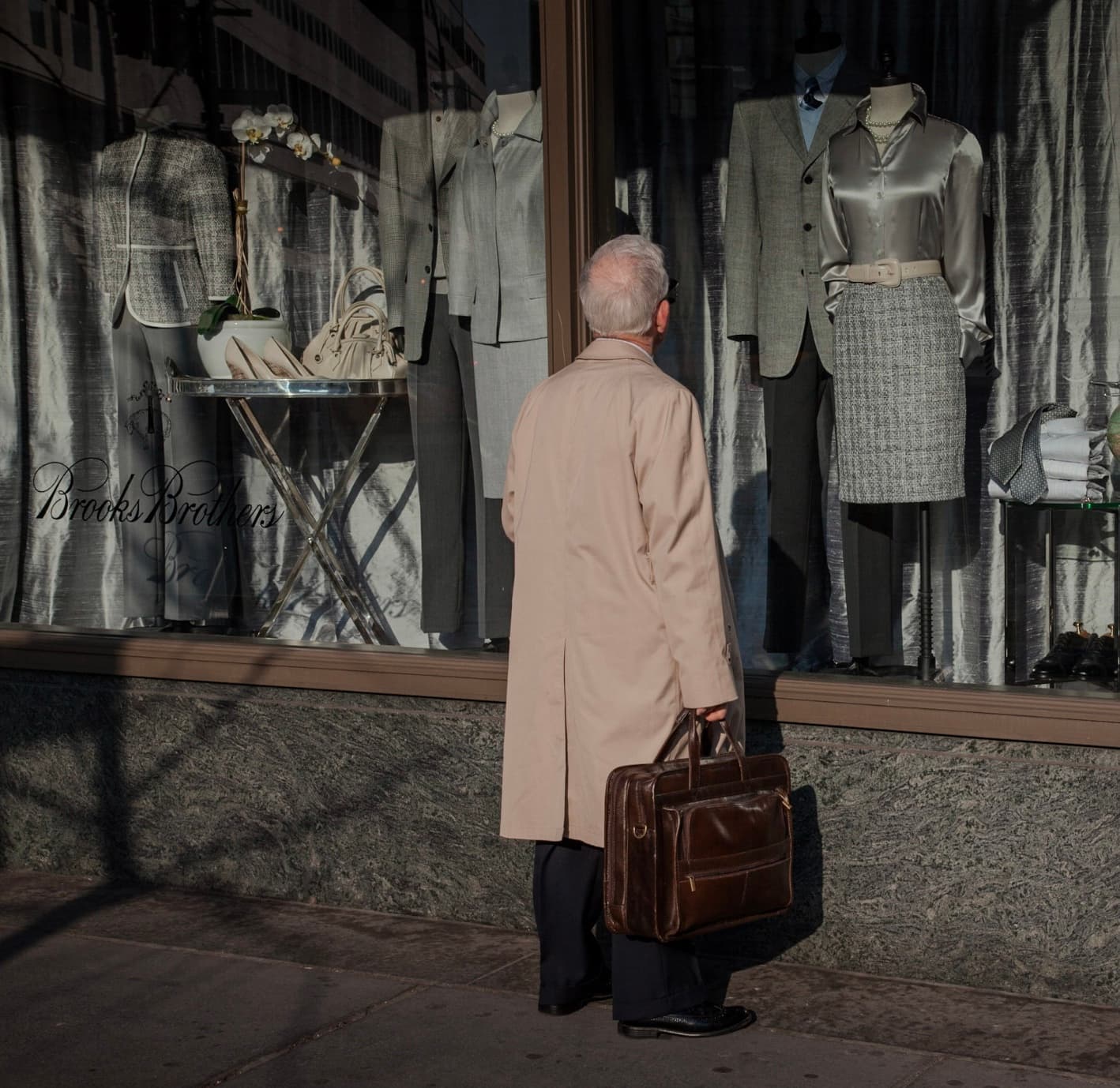 Window Gazing, an older man in a trench coat standing before a Brooks Brothers display
